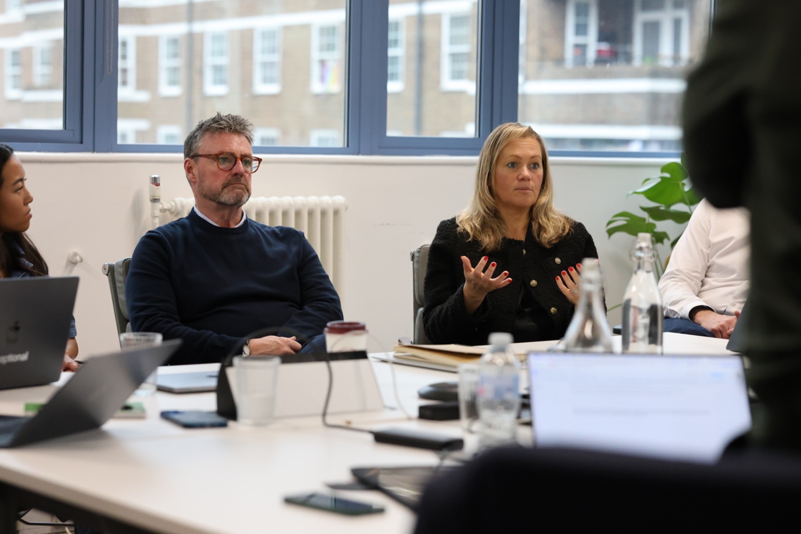 A leadership team in discussion around a boardroom table